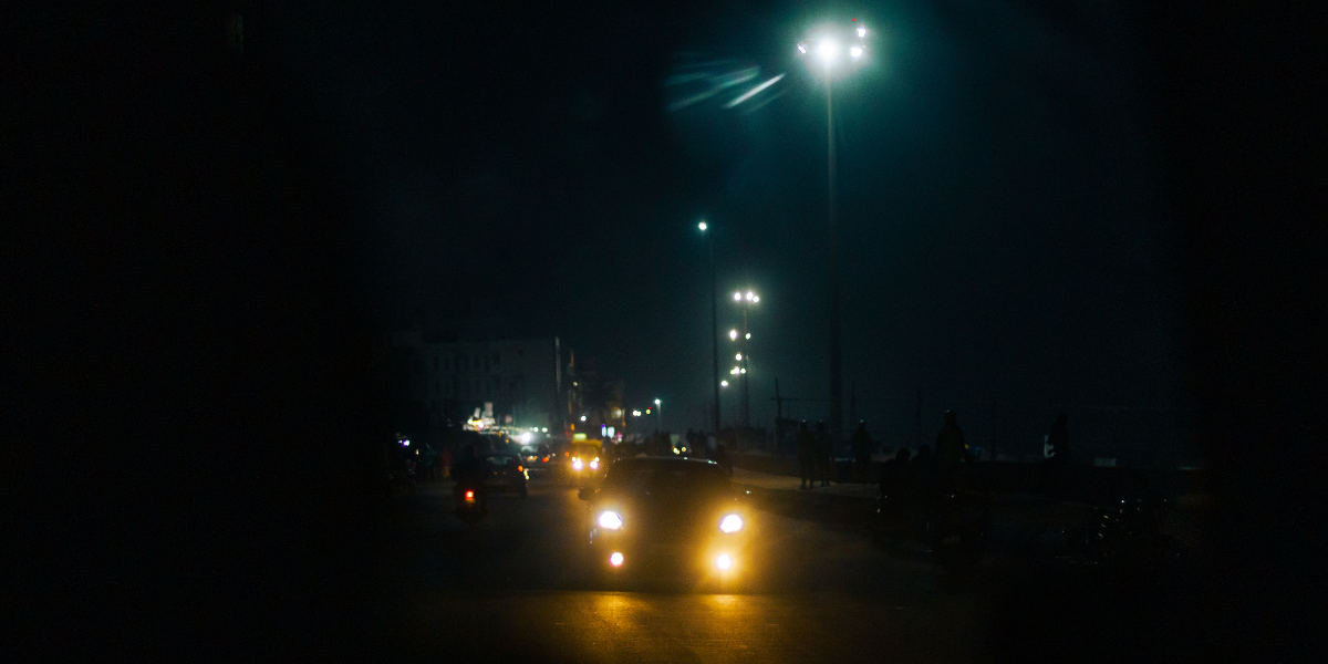 Car driving towards the camera at night