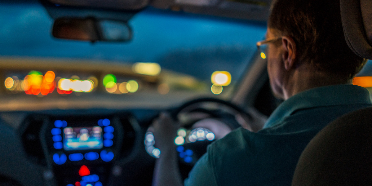 Person driving car at night