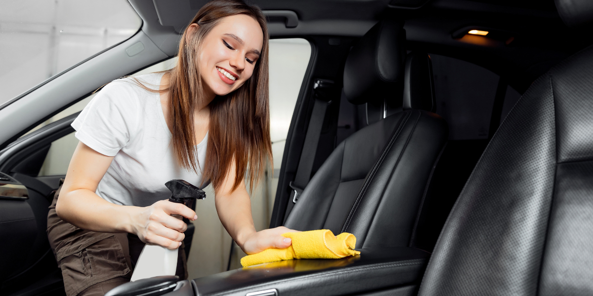 Photo of a lady cleaning a car interior