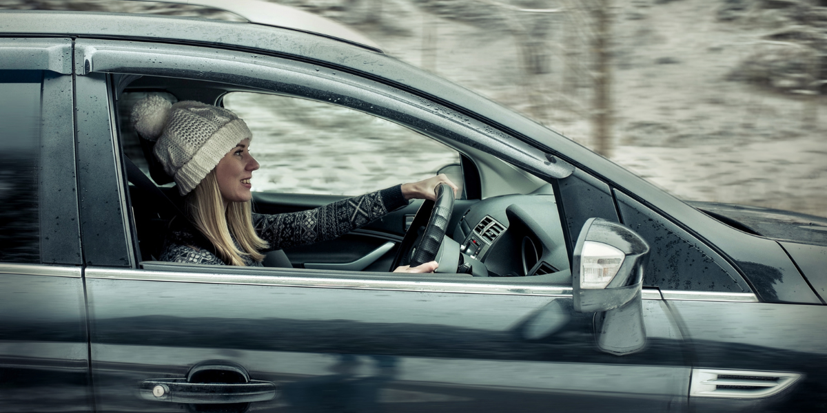 Photo of a lady driving in winter